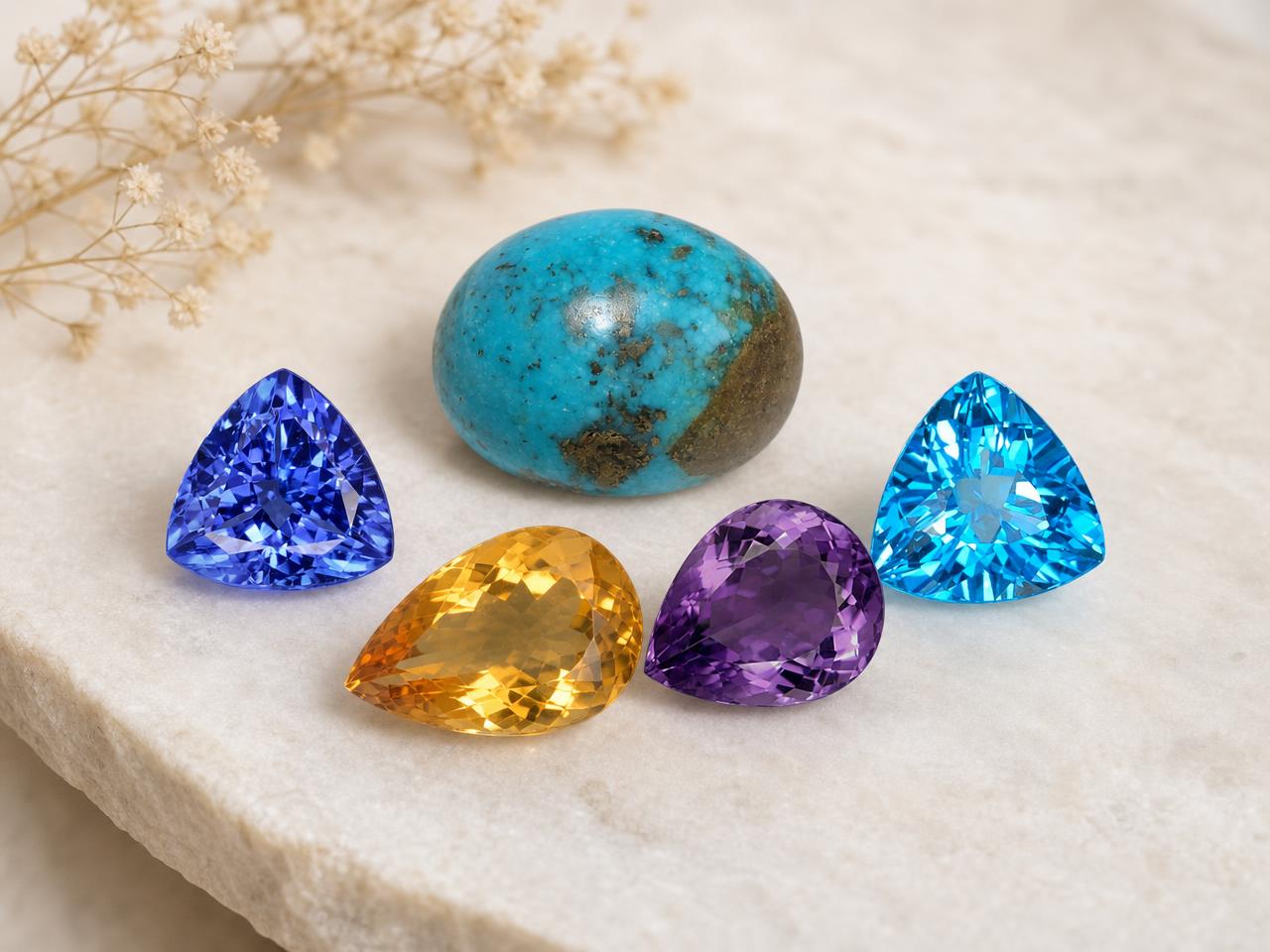 Piedras de nacimiento de Sagitario sueltas en colores azul, turquesa y dorado.
