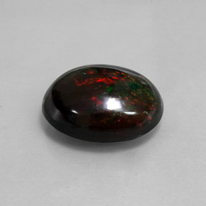 Ópalo negro multicolor natural de 8,82 ct, corte óvalo, opaco