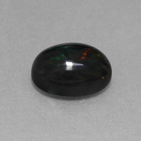 Ópalo negro multicolor natural de 1,27 ct, corte óvalo, opaco