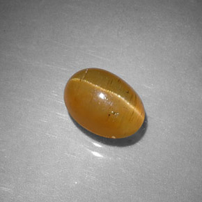 Apatita ojo de gato naranja natural de 1,43 ct, corte óvalo, translúcido