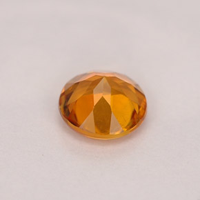 Clinohumite Naranja amarillo natural de 0.71 ct, Corte Redondo, VS