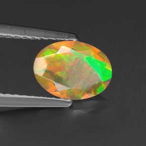 Ópalo multicolor natural de 0,69 ct, corte óvalo, transparente