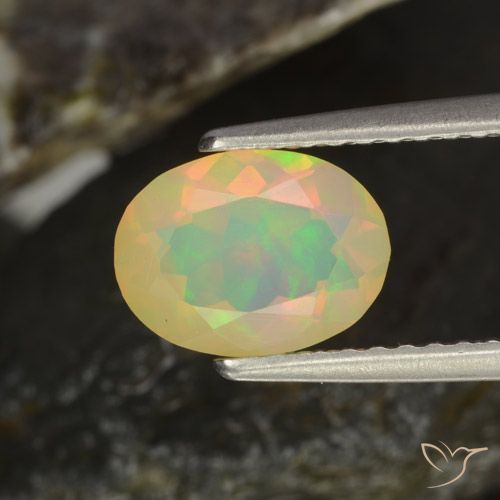 Ópalo multicolor natural de 0,94 ct, corte óvalo, transparente