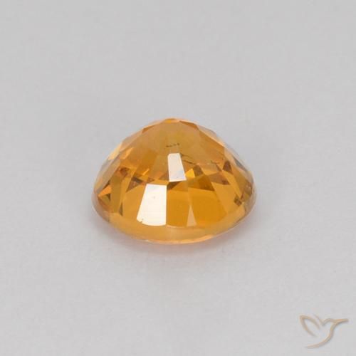 Zafiro Dorado naranja natural de 0.71 ct, Redondo, VS
