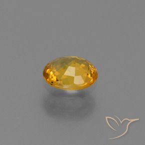 Zafiro Dorado naranja oscuro natural de 0.73 ct, Ovalada, VS