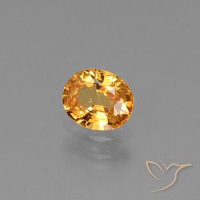 Zafiro Dorado naranja natural de 0.79 ct, Ovalada, VS