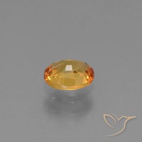 Zafiro Dorado naranja natural de 0.79 ct, Ovalada, VS