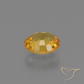 Zafiro Naranja dorado intenso natural de 0.64 ct, Ovalada, VS