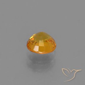 Zafiro Naranja dorado intenso natural de 0.76 ct, Redondo, VVS