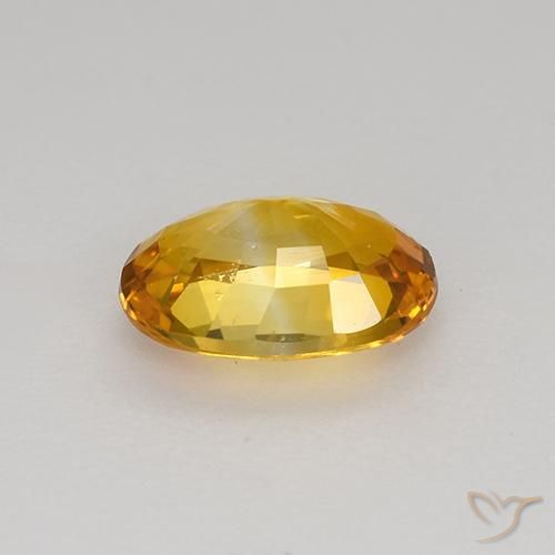 Zafiro Dorado naranja natural de 0.92 ct, Ovalada, VS