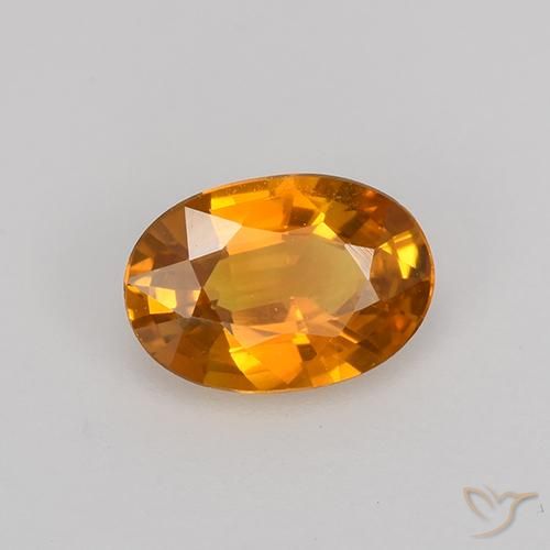 Zafiro Dorado naranja intenso natural de 0.72 ct, Ovalada, VVS