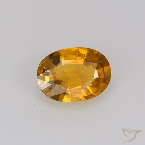 Zafiro Dorado naranja intenso natural de 0.71 ct, Ovalada, VVS