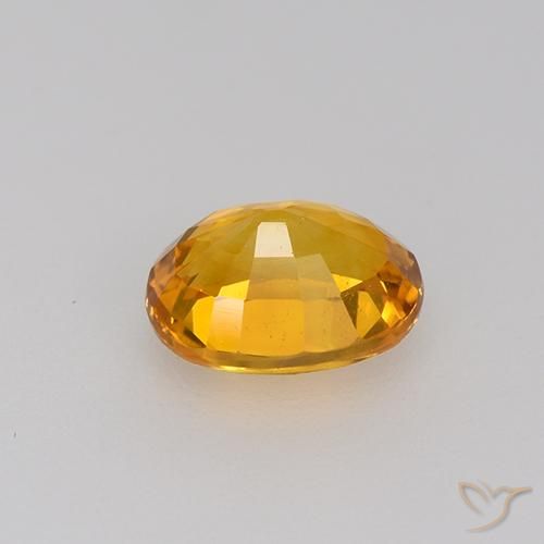 Zafiro Dorado naranja intenso natural de 0.81 ct, Ovalada, VVS