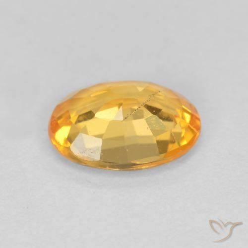 Zafiro Dorado naranja claro medio natural de 0.78 ct, Ovalada, VS