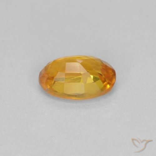 Zafiro Dorado naranja intenso natural de 0.56 ct, Ovalada, VVS-VS