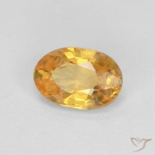 Zafiro Naranja dorado intenso natural de 0.56 ct, Ovalada, VS