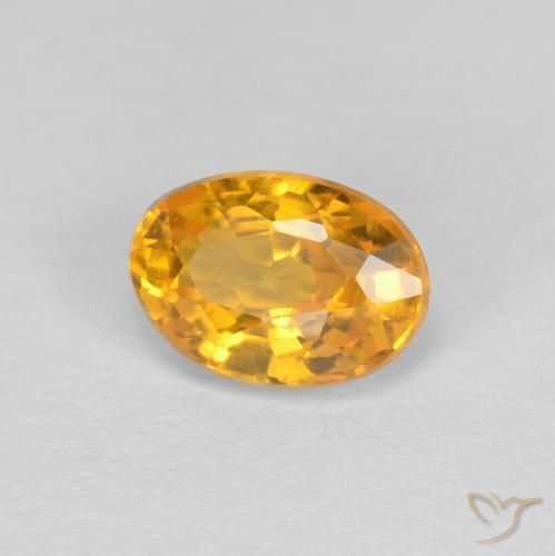Zafiro Dorado naranja natural de 0.60 ct, Ovalada, VVS
