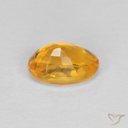 Zafiro Dorado naranja natural de 0.60 ct, Ovalada, VVS