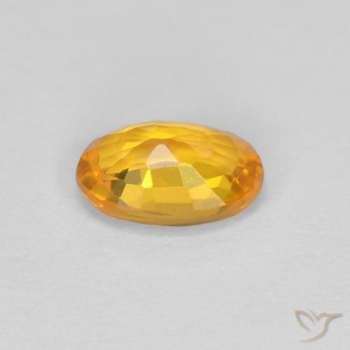 Zafiro Dorado naranja oscuro natural de 0.62 ct, Ovalada, VVS