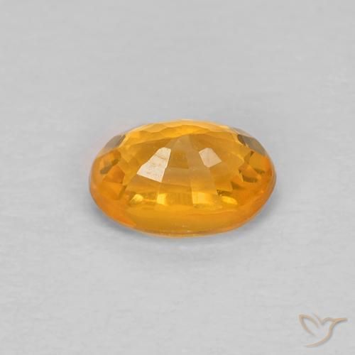 Zafiro Dorado naranja natural de 0.66 ct, Ovalada, VS