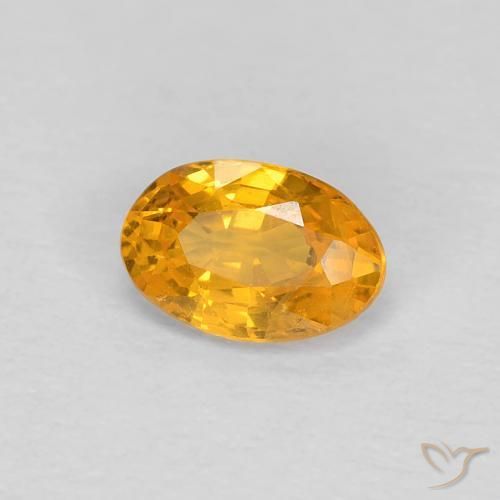 Zafiro Dorado naranja natural de 0.54 ct, Ovalada, VS