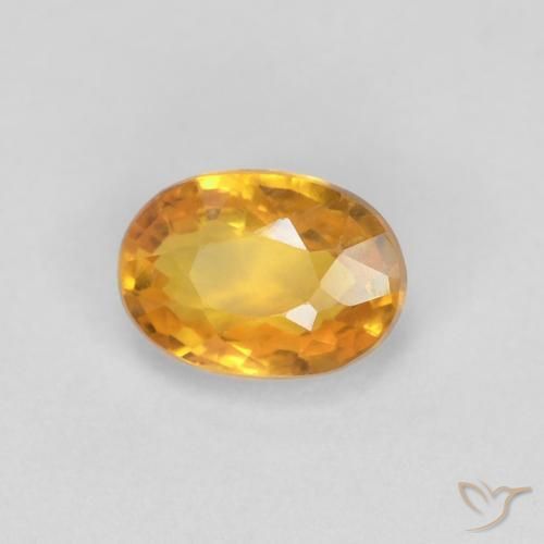 Zafiro Dorado naranja intenso natural de 0.65 ct, Ovalada, VVS