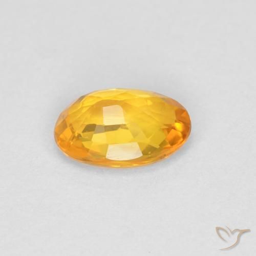 Zafiro Dorado naranja natural de 0.55 ct, Ovalada, VVS