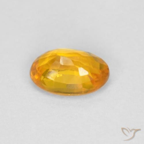 Zafiro Dorado naranja natural de 0.67 ct, Ovalada, VVS