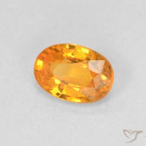 Zafiro Dorado naranja natural de 0.63 ct, Ovalada, VS