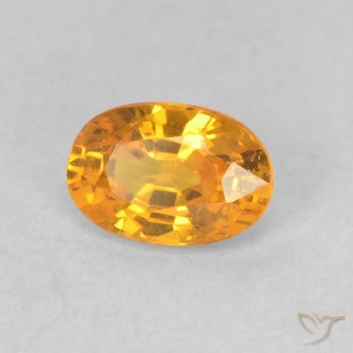 Zafiro Dorado naranja intenso natural de 0.66 ct, Ovalada, VVS-VS